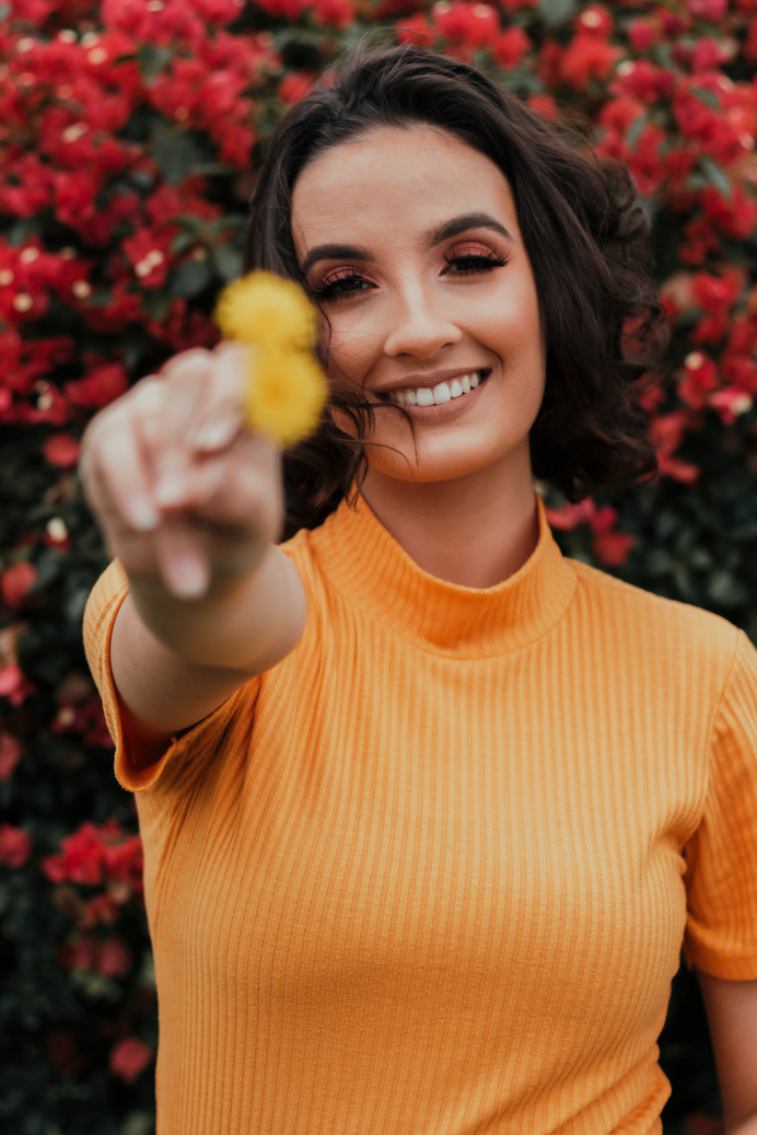 Photo of Woman Wearing Orange Top While Smiling